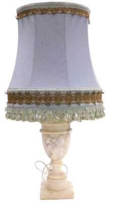 An alabaster table lamp, of vase and cover form, raised on a square base, with a blue fabric shade, 54cm high.