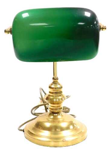 A brass desk lamp, with an angular green and white glass shade, 35cm high.