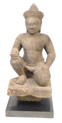 A Khmer sandstone figure of Varuna, in a seated door keeper pose as guardian of the west, possibly 10th/11thC, modelled wearing a sampot, with a jewelled headdress and collar, on a block fragment, raised on a black, rectangular base, 72cm high. Provenance