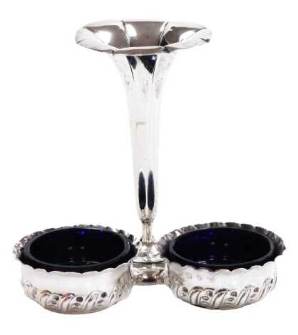 A pair of Victorian silver circular salts, with embossed scroll decoration, and unmatched blue glass liners, Vale Brothers & Sermon, Birmingham 1893, 1.5oz, together with a George V loaded silver bud vase, of octagonal trumpet form, Birmingham 1914, 12cm 