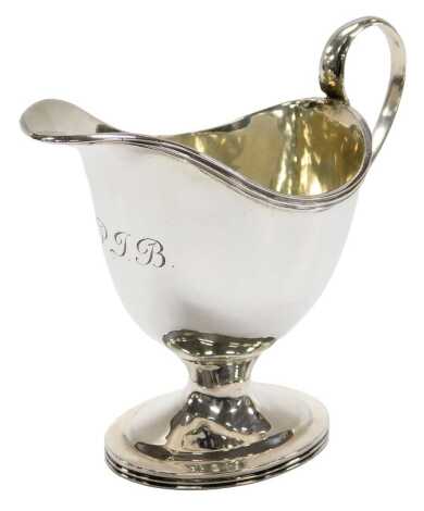 An Edwardian silver helmet shaped cream jug, with reeded rim, on a plain square foot, 11cm high, Stokes & Ireland Ltd, Chester 1907, 2.5oz.