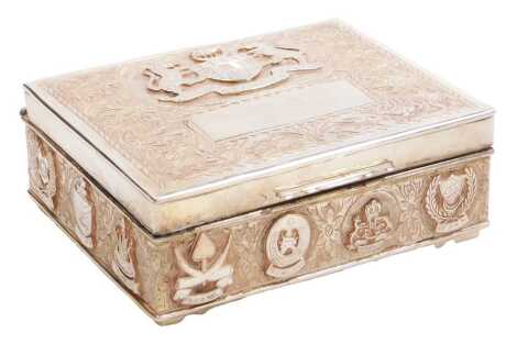 A 20thC Malay silver cigarette box, embossed with the Arms of Malaysia, and of the individual states, and engraved with flowers and scrolling leaves, raised on bracket feet, 12.5cm wide, 10.42oz all in.