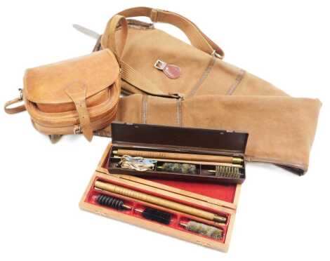 A canvas gun slip case, a leather cartridge bag, and two gun cleaning kits.