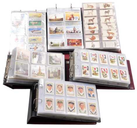 Cartophily Cigarette cards, John Player and Sons, in six albums, including Army Corps & Divisional Signs 1914-1918, RAF Badges, Military Head-Dress, Natural History, Cricketers 1934, Coronation Series Ceremonial Dress, and Players Past and Present, and fu