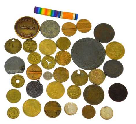 A small collection of coins and tokens, including Royal Artillery Canteen Woolwich, two spade guinea tokens, medal ribbon, etc.