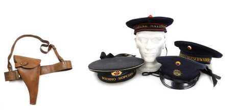 A WWI period British Army Sam Browne belt, with shoulder strap and leather revolver holster, a German, Russian and French military headdress, in the form of a German dress cap by Albert Kempfk, 1963, and a German Naval cap by Gebrúder Klotz, circa 1959, a