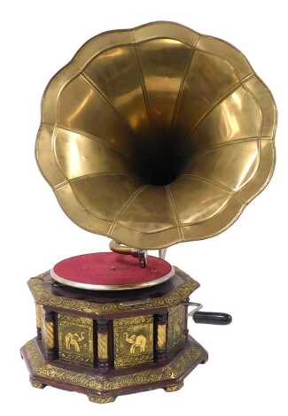 An Indian wooden and brass wind up gramophone, the octagonal case decorated in red lacquer and gilt with panels of elephants and flowers, with a brass horn, 66cm high.