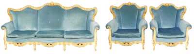 A continental Baroque style cream and parcel gilt three piece suite, upholstered in blue draylon, raised on cabriole legs, comprising a three seater sofa, 226cm wide, and a pair of armchairs.