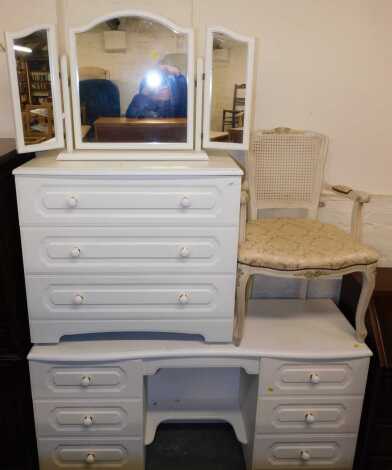 A bedroom suite, comprising a twin pedestal dressing table, with central makeup drawer, 144cm wide x 75cm high x 42cm deep, a chest of drawers, 82cm wide x 73cm high x 42cm deep, a triptych mirror, together with a boudoir chair, with rattan back infill, a