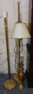 A pair of brass effect standard lamps, 150cm, together with another brass effect table lamp, 80cm.