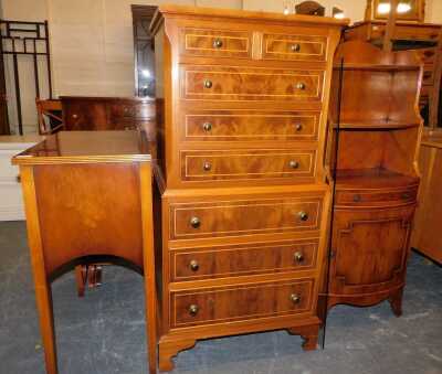 A reproduction chest on chest, sideboard lounge storage unit in yew wood finish, with a box wood banding inlay, together with a matching three drawer cabinet, bookcase with low level cupboard and a nest of three tables. (4)