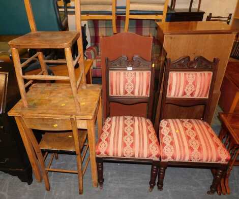 A pair of matching mahogany occasional chairs, with upholstered seats and back rests, scroll pediment detail with compass decoration, together with a beech and pine school desk, and two oak chairs. (5)