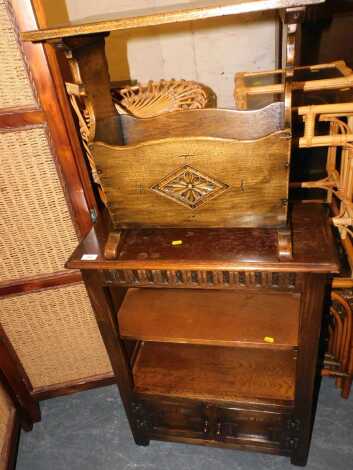 A hardwood cupboard bookcase, with two doors and open shelves, 67cm wide 88cm high x 30cm deep, together with a magazine rack with a carved diamond motif. (2)