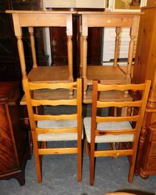 A pine kitchen table with two pine ladder back chairs, and a pair of pine side tables, with low level storage shelf, table measures 100cm long x 60cm wide x 50cm deep. (5)