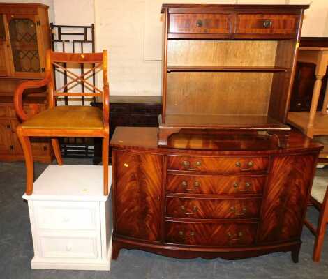 A reproduction flame mahogany sideboard, with brass escutcheons, four drawers, two side cupboards, 132cm wide x 88cm high x 45cm deep, together with a bookcase, two frieze drawers, painted oak effect two drawer bedside unit, 52cm wide x 56cm high x 47cm d