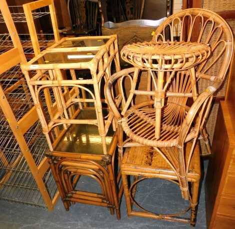 Rattan and glass conservatory furniture, including a nest of tables, chair, footstool and an occasional table.