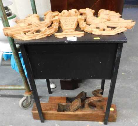 A mid 20thC ebonised sewing table, together with a wooden door pediment, carved with griffins and fruit, and two jointer planes.