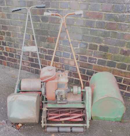 A Suffolk Punch Duel Drive MK7 lawnmower, together with a hand powered lawnmower with roller.