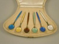 A Harlequin set of Norwegian and white metal and enamel coffee spoons