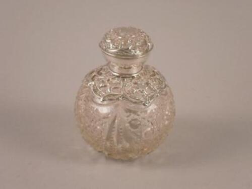 A silver mounted cut glass scent bottle with inner stopper