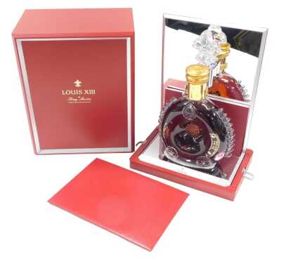 A bottle of Remy Martin Louis XII Cognac, in presentation box, with registration number KA-8163.