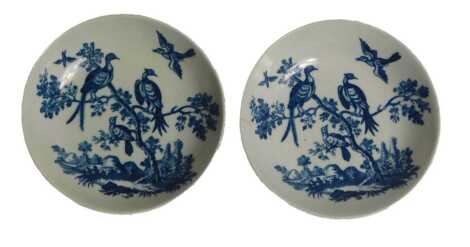 A pair of late 18thC Worcester porcelain saucers, printed on blue with birds in branches pattern, under glazed blue, hatched crescent mark, 13cm diameter. Upon initial inspection there is a visible hairline crack to one saucer running from edge towards fo