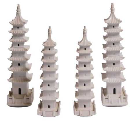 A group of four Chinese porcelain white glazed pagodas. On initial inspection, all pagodas appear to be in good condition. The larger pair measure 26.5cm high and 6.25cm wide, whilst the smaller pair measure 22cm high and 5.25cm wide.