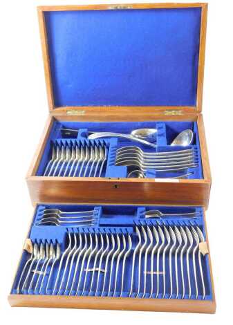 A canteen of cutlery, Old English pattern, with feathered edge and monogram, London 1900, in oak case, 103oz overall. Retailed by John Hall & Co. Manchester.