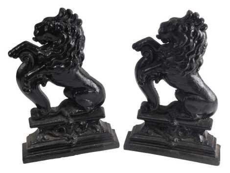 A pair of 19thC cast iron doorstops, each modelled in the form of a lion, on a tapering base, 38cm high.