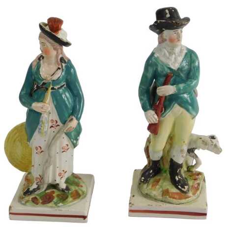 A pair of early 19thC Staffordshire figures, depicting Huntsman, one with spaniel, on square base, 16cm high. (AF) Upon initial inspection the female figure has numerous losses to glaze, three corners to the plinth are scuffed and lacking glaze, small chi