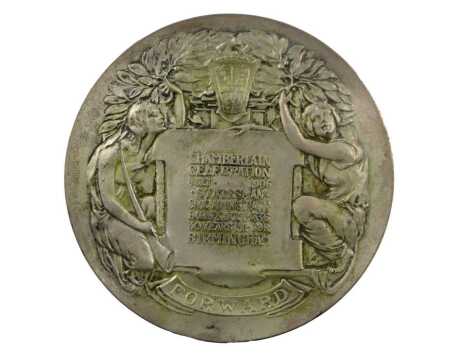 A silvered metal medallion, struck to commemorate Joseph Chamberlain, 7.5cm diameter.