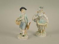 A pair of 20thC Dresden porcelain figures of a gentleman with eggs and game birds and a lady with fl