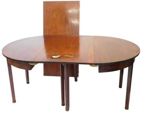 A George III mahogany dining table, with gate leg action, two D-ends supporting, two additional leaves, on tapering legs, 244cm x 142cm extended.