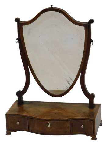 A George III mahogany and rosewood cross banded dressing mirror, the shield shaped plated on shaped supports, the serpentine fronted box base with three drawers, on ogee bracket feet, 42cm high. Estimate £60-£80.