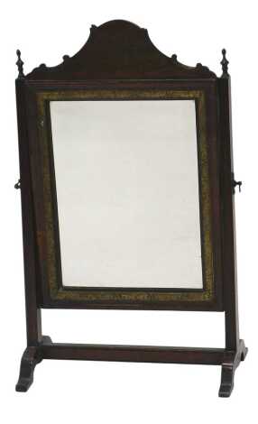 An 18thC mahogany and parcel gilt rectangular dressing table mirror, the bevel plate within a moulded frame, with shaped crest, on tapering supports, mounted with turned brass finials, splayed legs, 34cm wide.