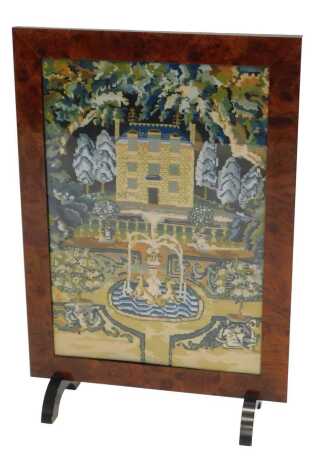 A mahogany firescreen, inset with an embroidered banner of country house and fountain, etc., 80cm high, 54cm wide.