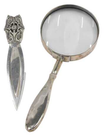 A silver and marcasite ornate bookmark, and a magnifying glass with white metal handle. (2)