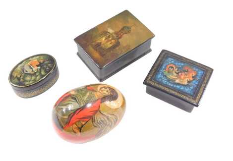 A Russian painted papier mache and lacquered rectangular box, the lid decorated with a church embellished in a mother of pearl, 9cm wide, two other Russian boxes, and a painted Russian egg decorated with a Saint. (4)