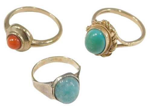 A 9ct gold and turquoise ring, size M½, 9ct gold and coral ring, in a circular design, size N, and a blue hard stone ring, set in yellow metal, unmarked, size H½, 8.2g all in.