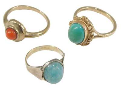 A 9ct gold and turquoise ring, size M½, 9ct gold and coral ring, in a circular design, size N, and a blue hard stone ring, set in yellow metal, unmarked, size H½, 8.2g all in.