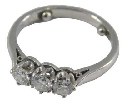 A platinum and diamond three stone ring, in high claw setting, approximately 0.5ct, stamped 950, size K, 4.7g.