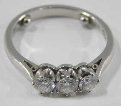 A platinum and diamond three stone ring, in high claw setting, approximately 0.5ct, stamped 950, size K, 4.7g. - 2