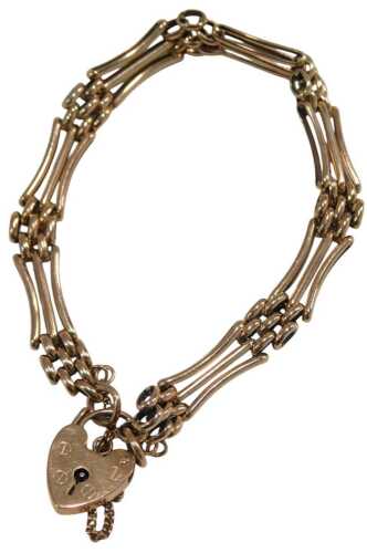 A 9ct rose gold three bar gate bracelet, on a heart shaped padlock clasp, with safety chain as fitted, 14.9g.