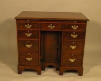 An early 20thC mahogany kneehole desk