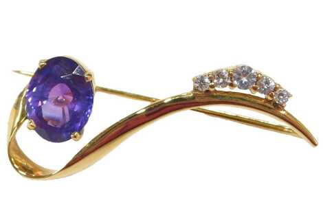 A scroll design sapphire brooch, set with a purple sapphire of medium saturation, 10mm x 7.8mm x 4.9mm, approx 3.21ct, white five white stone set round brilliant cut stone ends, comprising two synthetics, 1.6mm, two topazes, 2.1mm, and one topaz 2.8mm, of