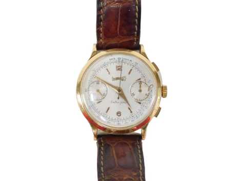 An Eberhard & Co gent's chronograph wristwatch, with a silvered numeric dial, with gold hands and seconds dial, the bezel stamped E, numbered to reverse 14007-516, in a 9ct gold case, the dial 4.5cm diameter, on brown leather strap, 52.1g all in.