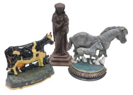 A Victorian cast iron door stop, modelled in the form of a maiden, lozenge mark to reverse, 39cm high, and two other door stops, one modelled as a cow (Buttercup), and the other of two horses. (3)