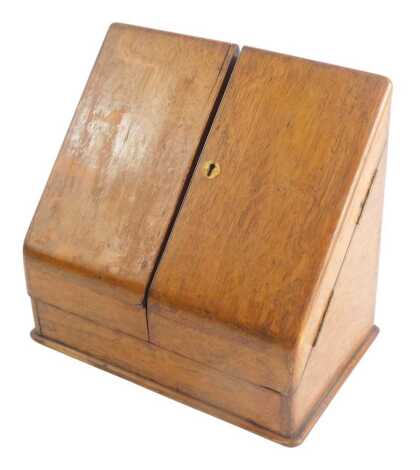 An oak writing box, with hinged sloping doors, and a fitted interior above a drawer, 29cm wide.