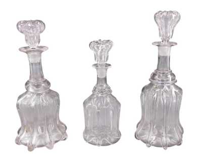 Two similar 19thC mallet shaped decanters and stoppers, 32cm x 31cm high respectively, and a smaller example, 29cm high.