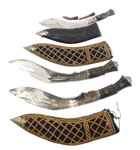 A pair of Indian Kukris, each with a horn handle, and fabric covered scabbard, and another similar. (3)